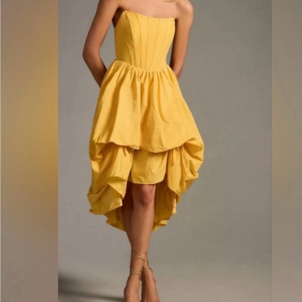 Anthropologie Strapless Corset-Style Yellow Dress in with a subtle balloon hem.